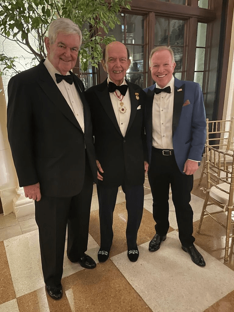 Kent Emmons in black tie with two guests at the Ambassadors Gala